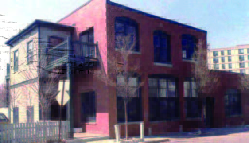 carriage (1) Two-story brick building with large windows and an external staircase on a sunny day.