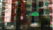 highland (1) Pixelated image of a brick building with trees in front and a green sign above the entrance.